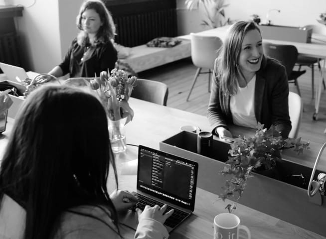 women sitting at a desk